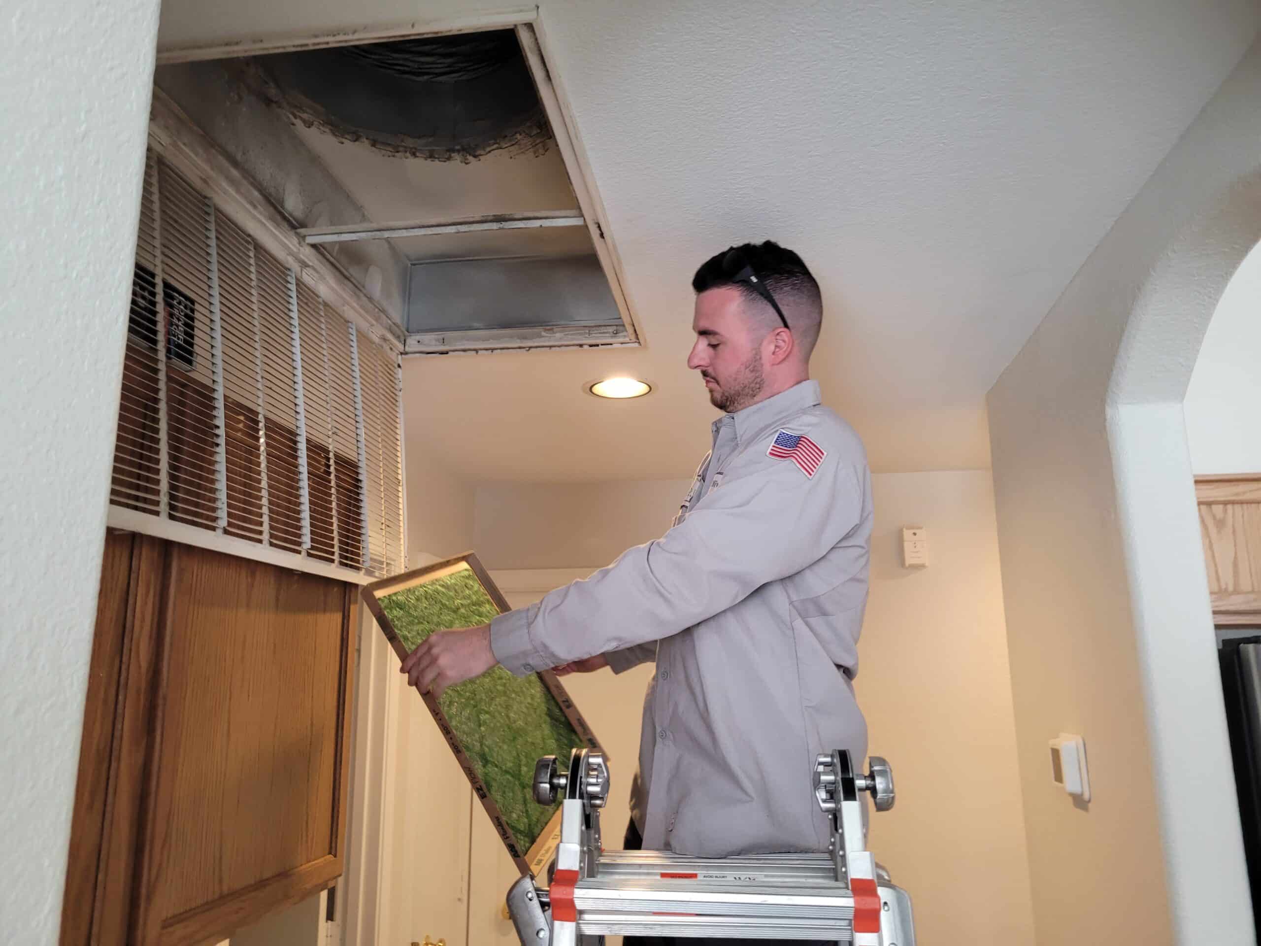 Technician working on an AC unit in Mesa, AZ, performing repairs to ensure optimal cooling and system efficiency.