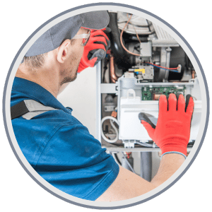 HVAC technician calibrating a thermostat during a heating tune-up