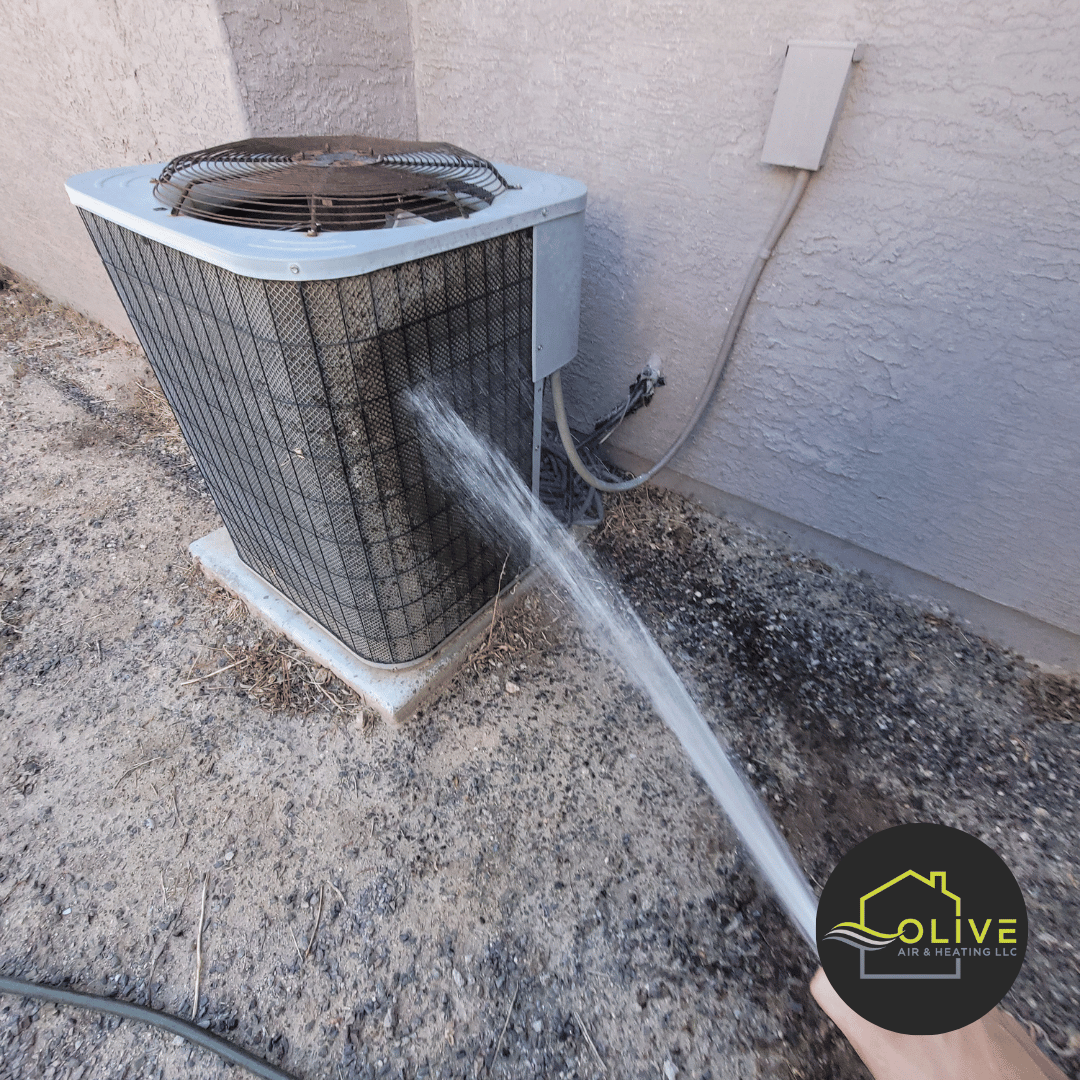 Technician carefully cleaning an AC unit's exterior and interior components to ensure optimal performance and prevent dust buildup.