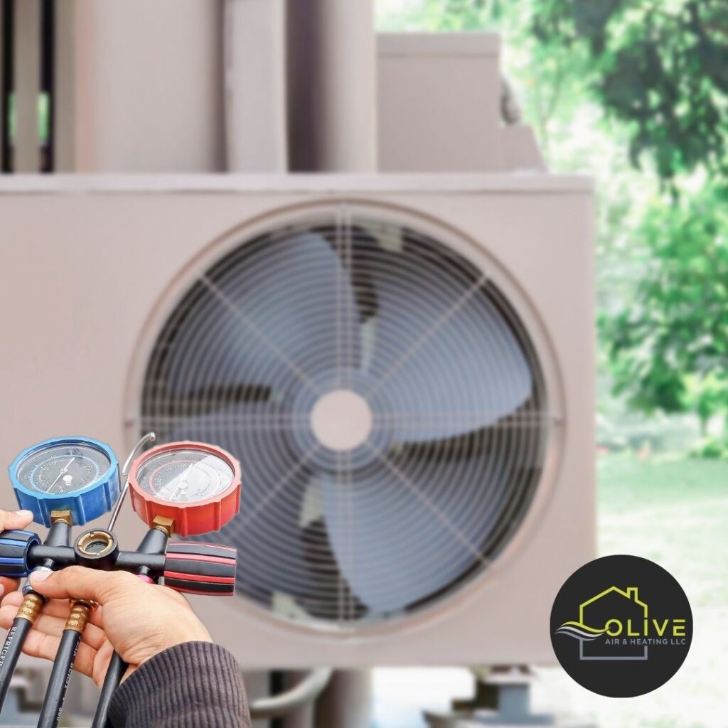 An HVAC technician performing an AC Tune-Up in Gilbert, AZ, checking the refrigerant levels in an outdoor unit.