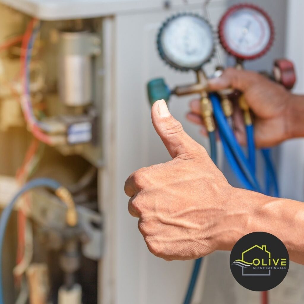 Close-up of an HVAC technician performing an AC Tune-Up, inspecting internal components to ensure optimal performance.