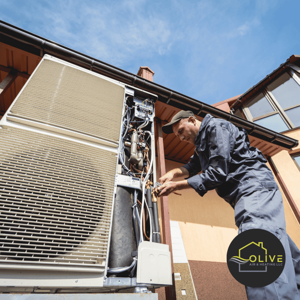 Olive Air and Heating LLC technician fixing electric control issues in an AC unit, ensuring proper functionality.