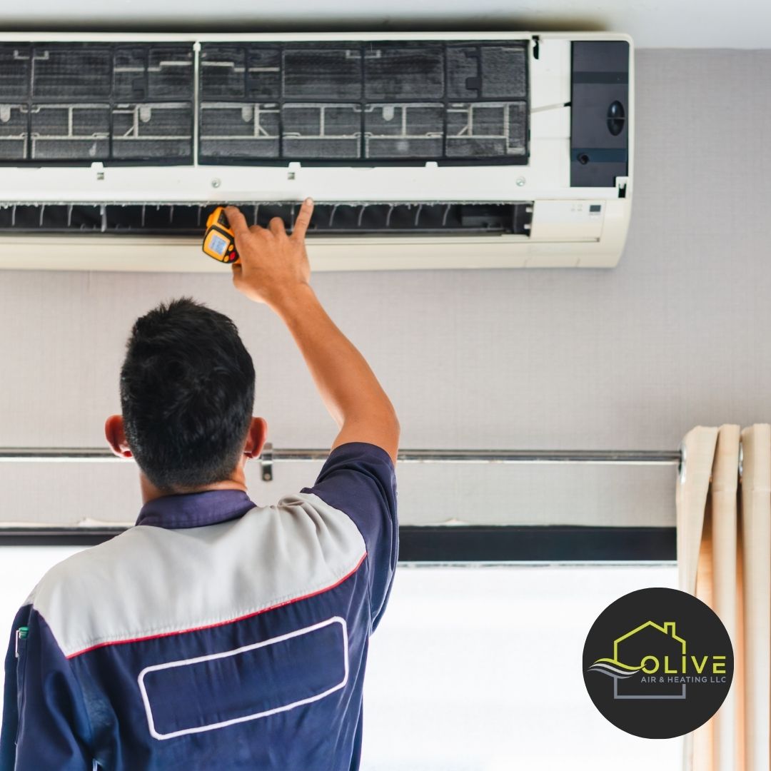 HVAC technician carefully calibrating an AC system during a routine tune-up to ensure optimal efficiency and performance.