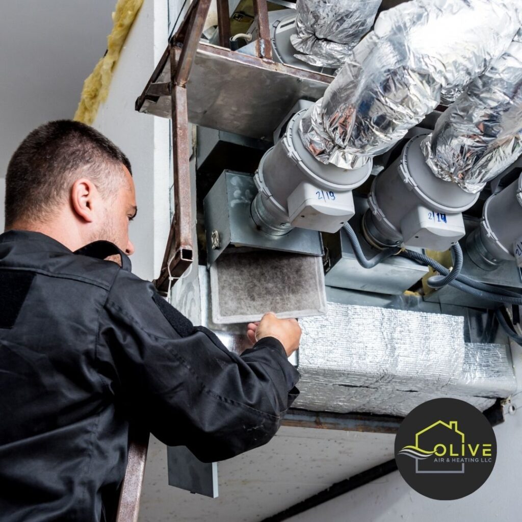 HVAC technician examining the drainage system of an AC unit in Tempe, checking for blockages and proper functionality to prevent water damage.