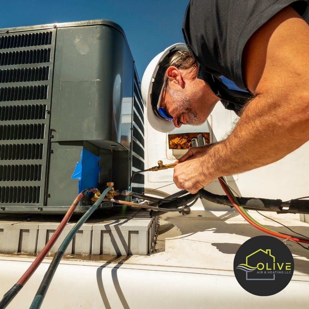 An HVAC technician replacing dirty air filters with new ones during a routine AC and heating tune-up to improve air quality and system efficiency.