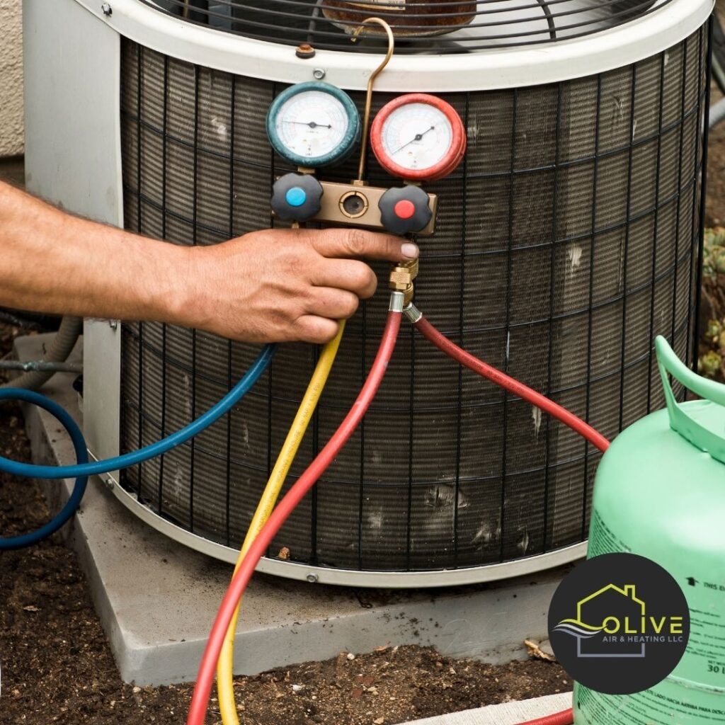 An HVAC technician adjusting the settings on an air conditioning unit during an AC Tune-Up service.