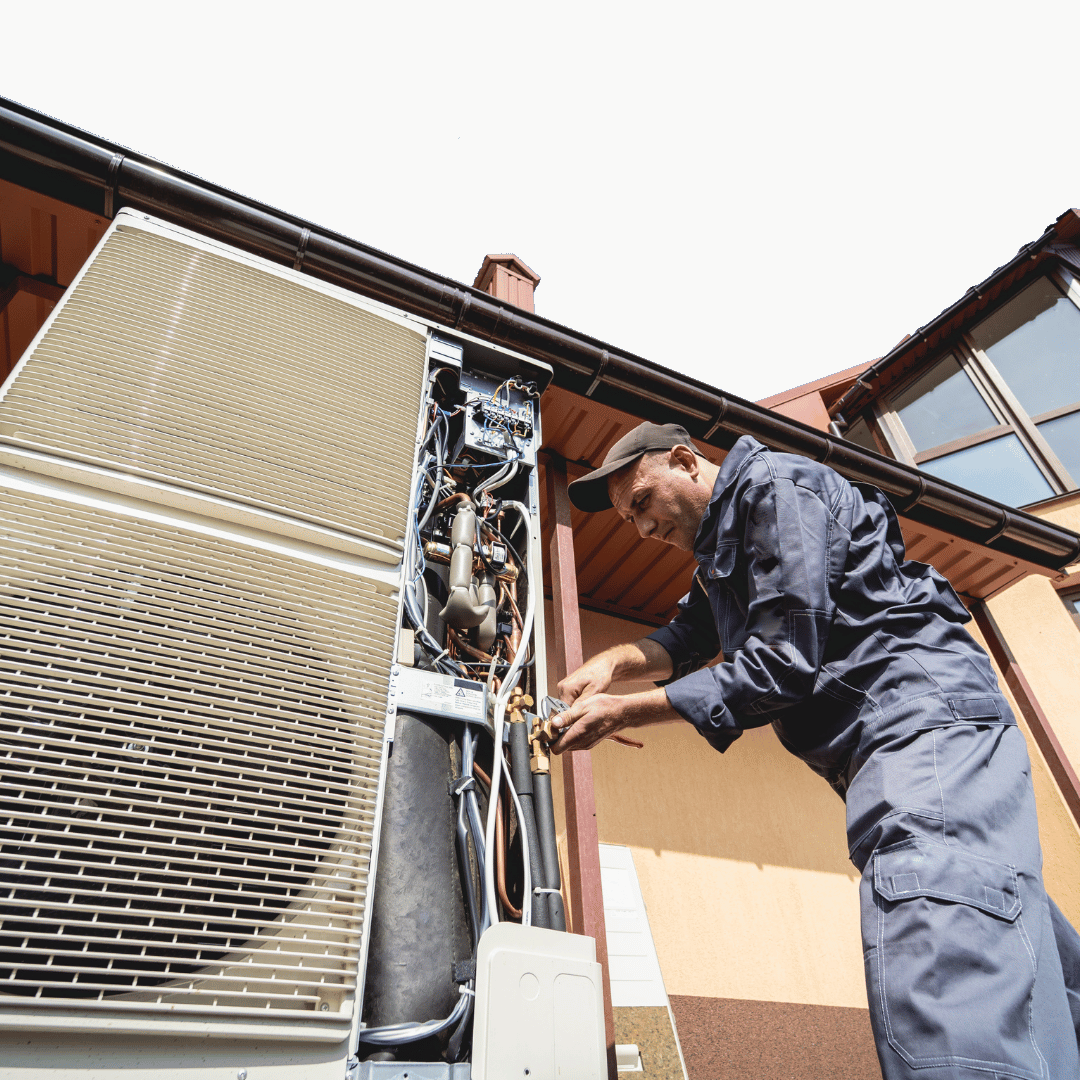 HVAC technician conducting a combined AC and heating tune-up in a residential home