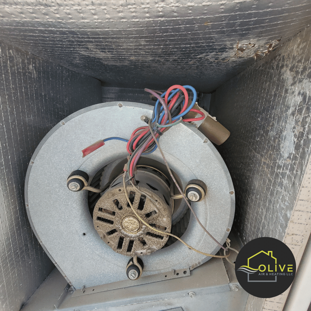 Olive Air technician replacing a worn-out fan motor in an AC system, a common issue that affects cooling efficiency.