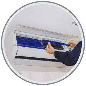 HVAC technician performing a tune-up on an air conditioning and heating system