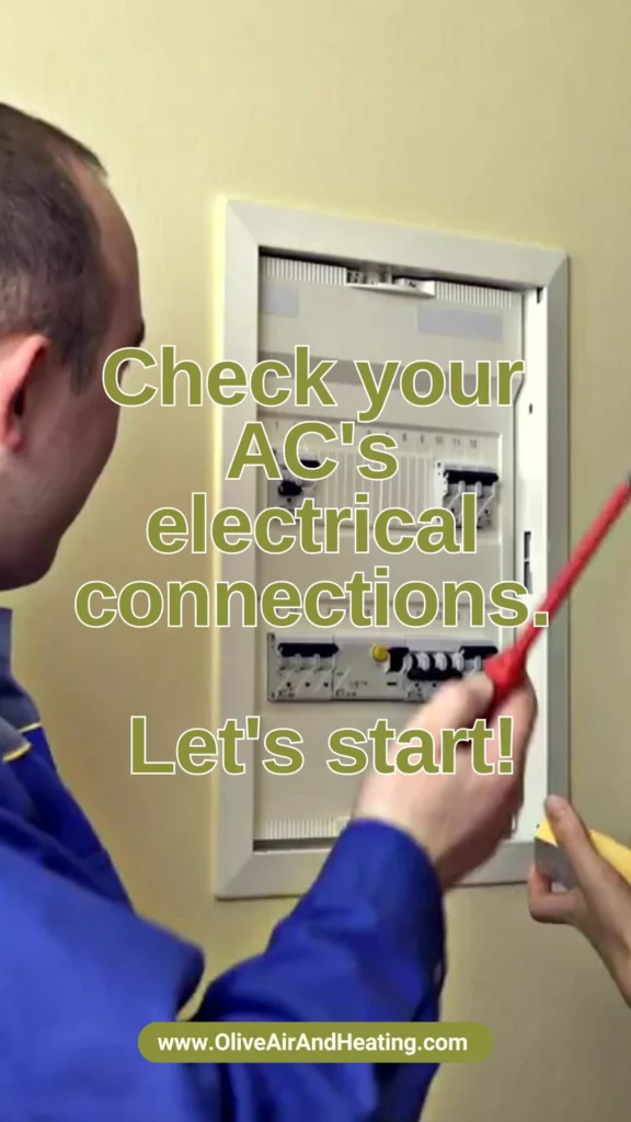 Olive Air technician carefully inspecting the electrical connections of an AC unit to ensure safety and identify potential repair needs.