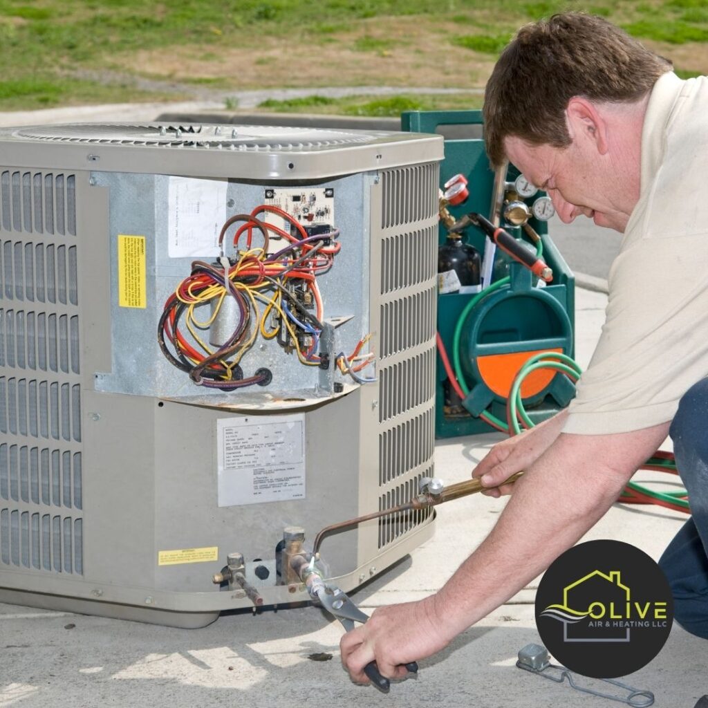 An HVAC technician conducting an AC Tune-Up in San Tan Valley, inspecting the air filters and condenser unit.