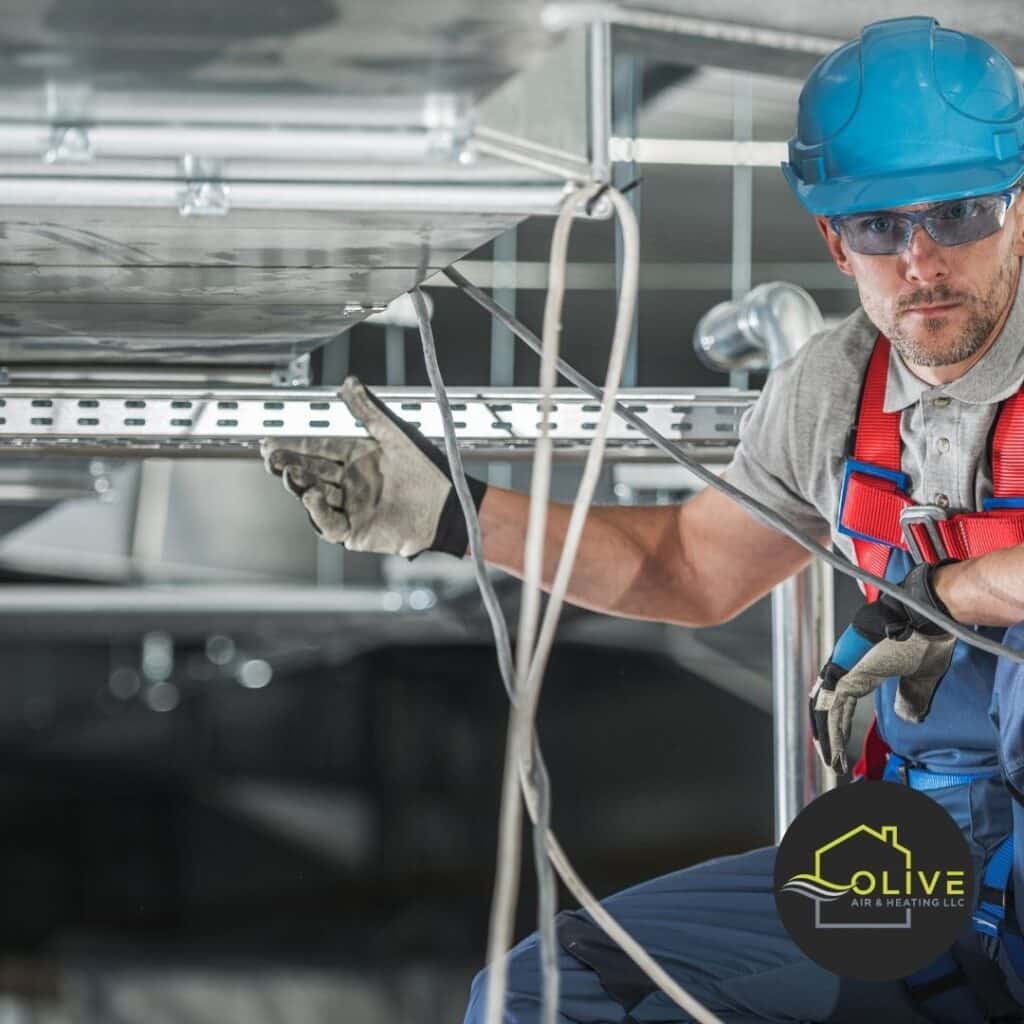 HVAC specialist inspecting system during AC & Heating Tune-up