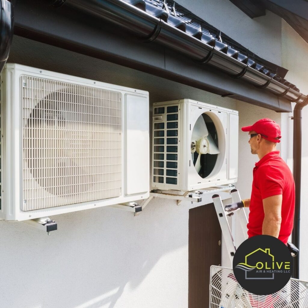 Technician adjusting settings during AC & Heating Tune-up for weather readiness