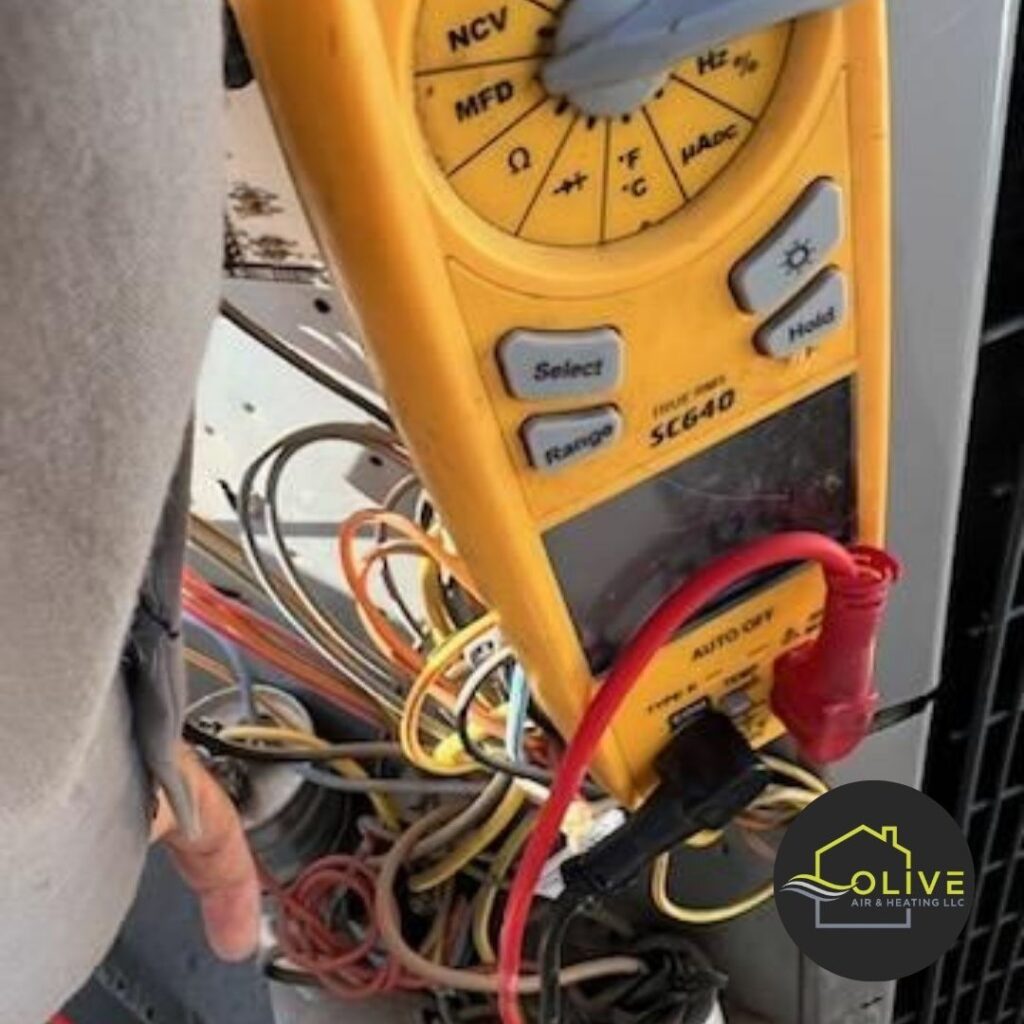 A technician using a multimeter to measure voltage and current in an outdoor AC unit. Regular AC tune-ups include electrical inspections to identify and address potential issues, such as faulty wiring or malfunctioning components. AC Repair