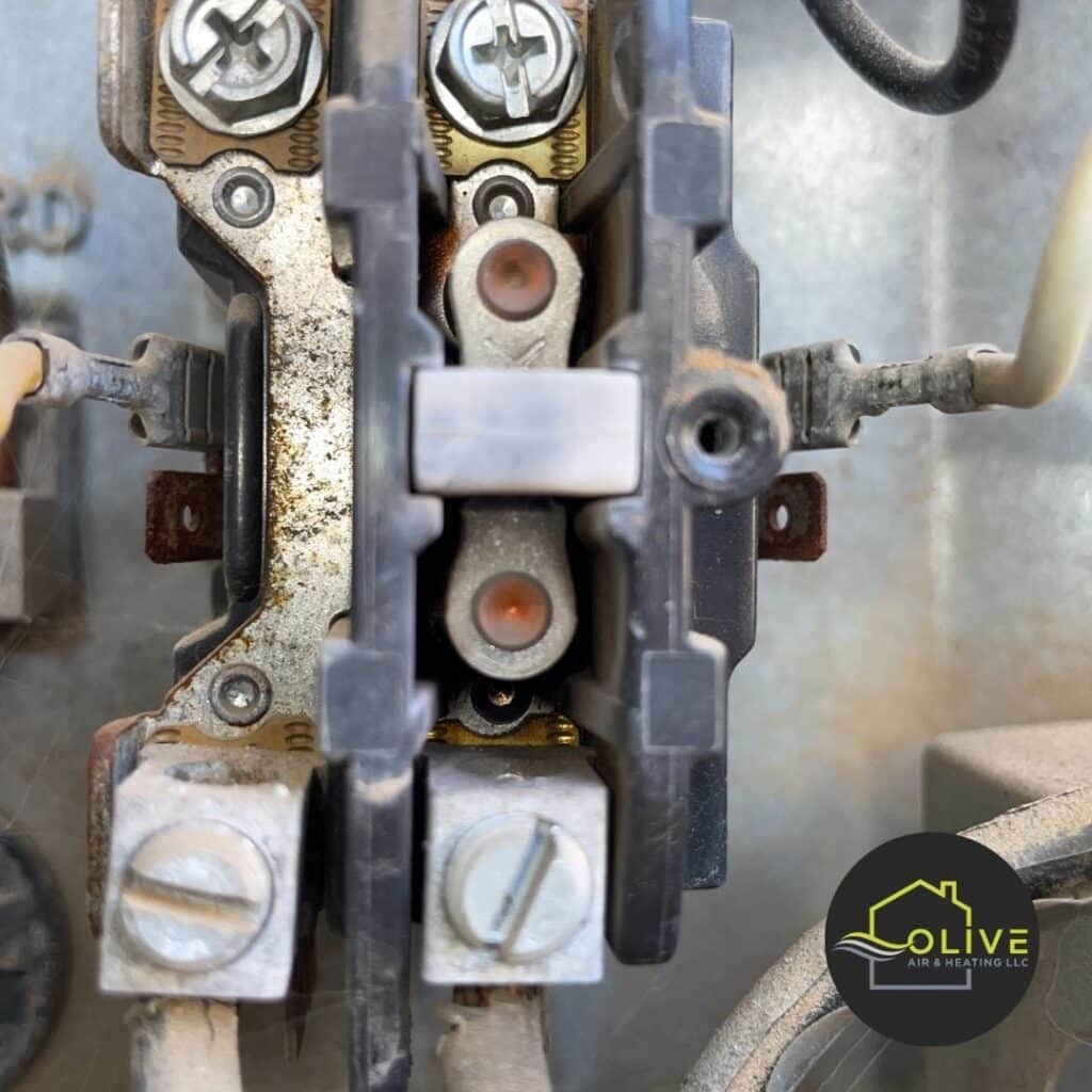 A close-up image of a corroded contactor in an air conditioner, highlighting the importance of regular AC tune-ups to identify and replace faulty components. AC Tune Up Gilbert