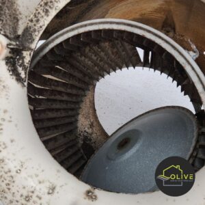 A close-up image of a severely clogged blower wheel, covered in a thick layer of dust, dirt, and debris. This can significantly reduce airflow, decrease heating system efficiency, and degrade indoor air quality. Regular Heating Repair can help keep the blower wheel clean and running smoothly.