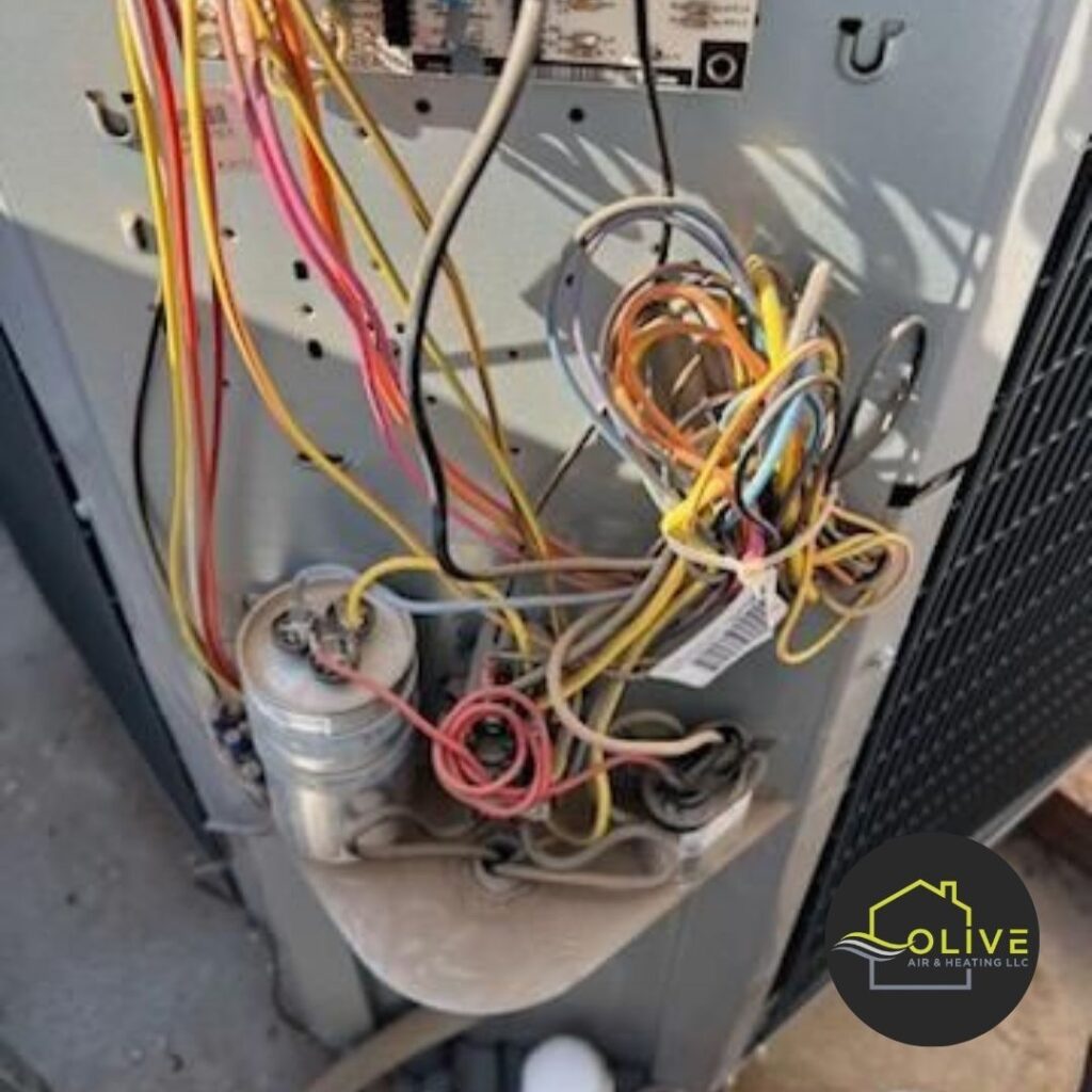 A close-up image of a cluttered and messy electrical panel inside an AC unit. This type of disorganized wiring can lead to electrical shorts, safety hazards, and reduced system efficiency. Regular AC tune-ups can help identify and address potential electrical issues, ensuring safe and efficient operation. Ac Repair