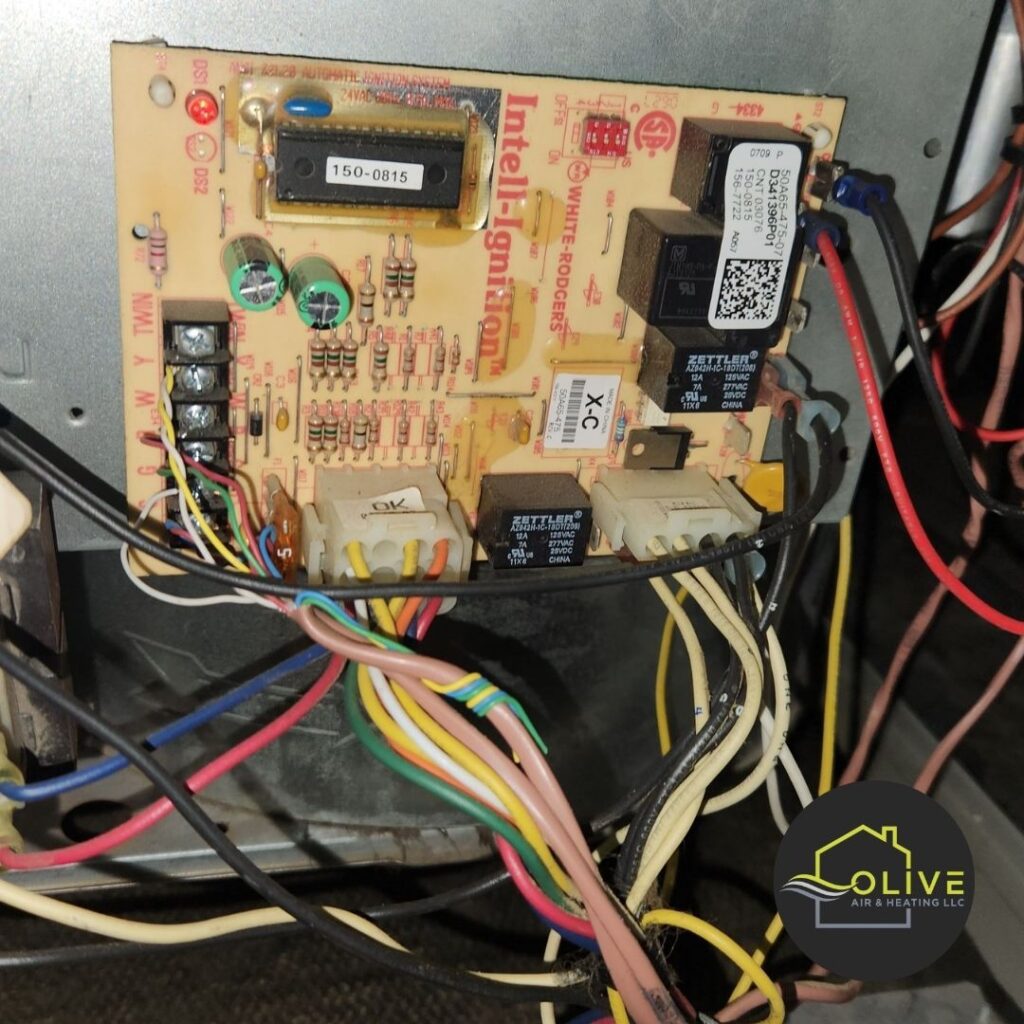 A close-up of a complex AC and Heating Tune Up control board, highlighting the potential risks of attempting DIY maintenance on intricate systems