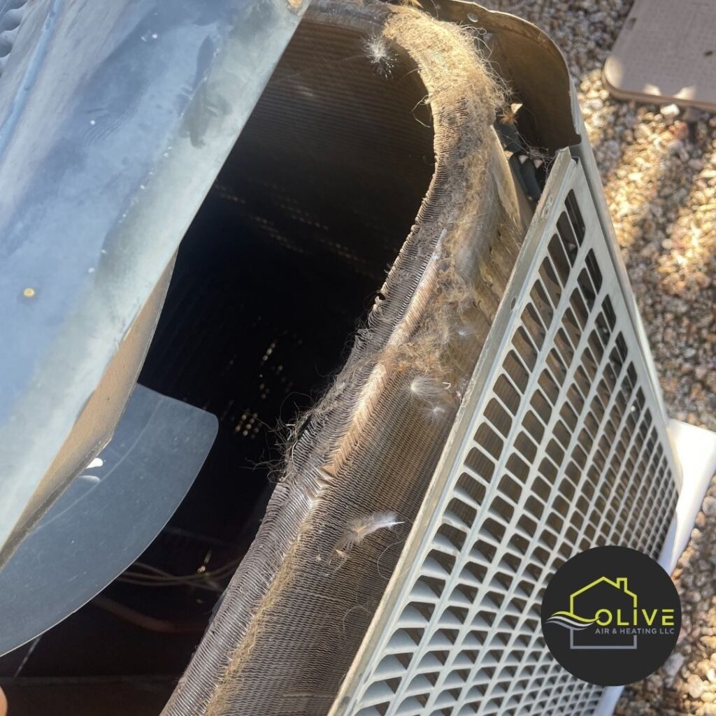 A close-up image of a dirty air conditioner coil, emphasizing the importance of regular AC tune up to remove debris and improve efficiency. AC Repair Gilbert