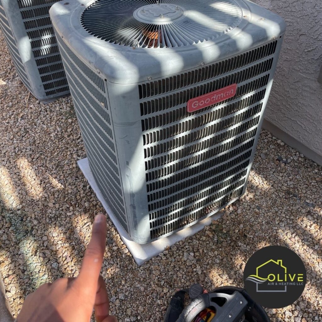 A technician inspecting an outdoor air conditioning unit in Gilbert, Arizona, ensuring optimal performance and energy efficiency during the winter months. Heating Repair Gilbert