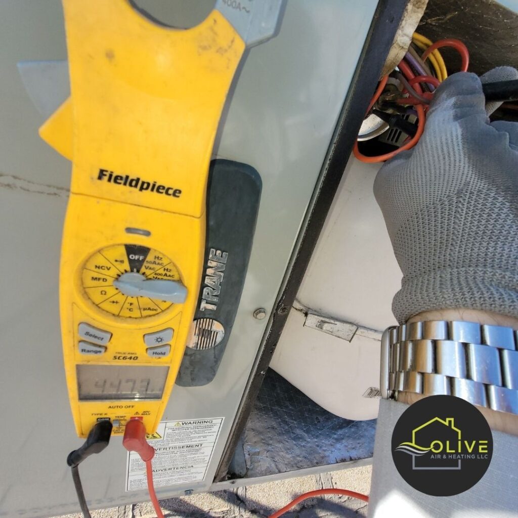 AC repair technician diagnosing a dead air conditioning unit during an emergency service call