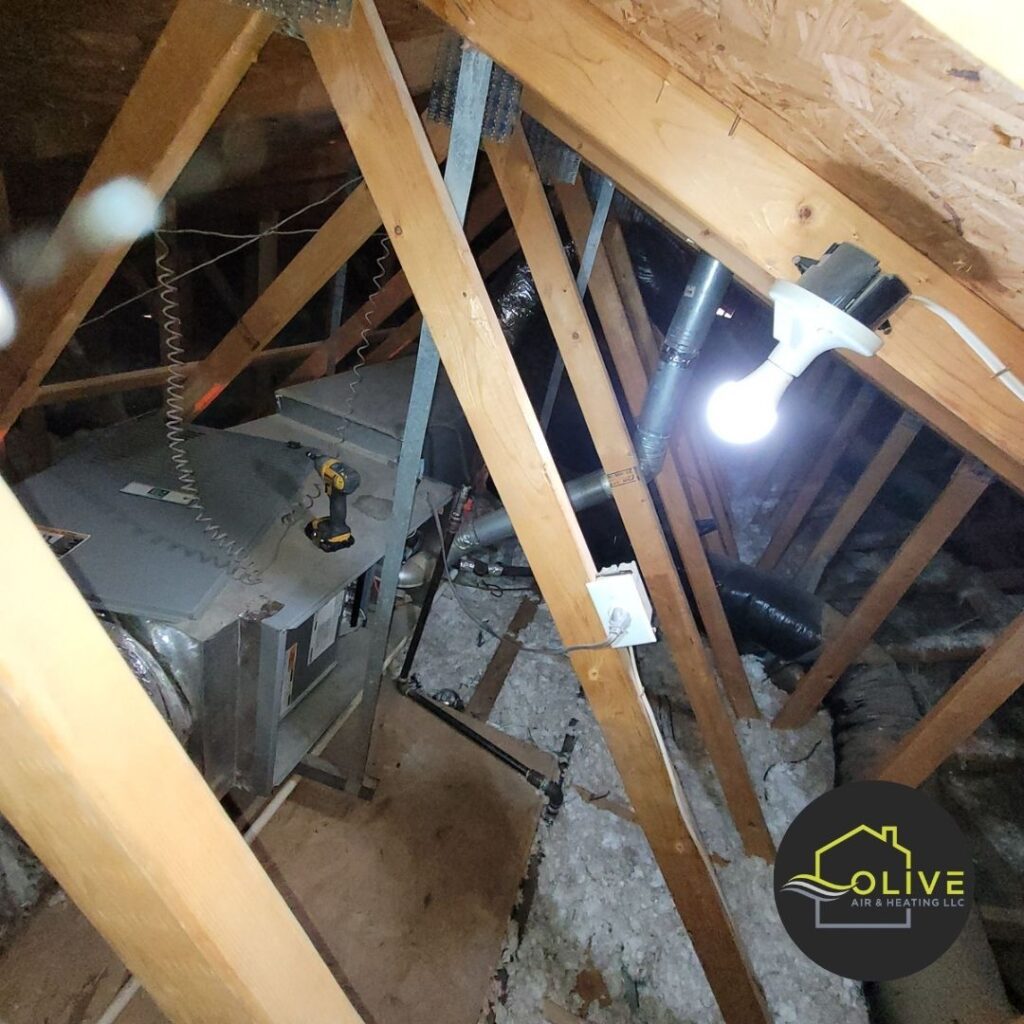 An image showing a poorly insulated attic with exposed ductwork and a furnace, heating repair. Inadequate insulation can lead to significant heat loss, resulting in higher energy bills and discomfort.