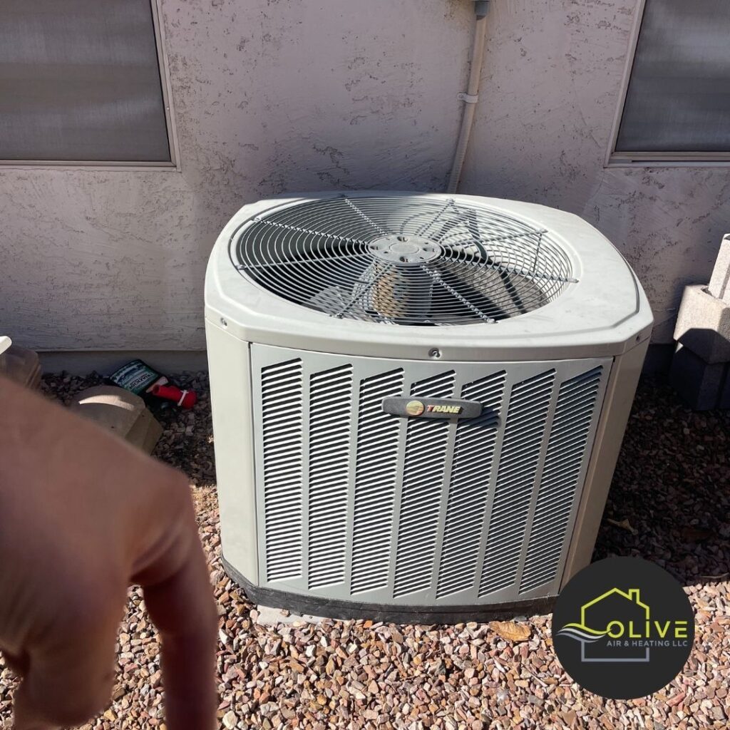 A technician inspecting an outdoor air conditioning unit in Mesa, Arizona, emphasizing the importance of regular heating and cooling system maintenance. Heating Repair Mesa