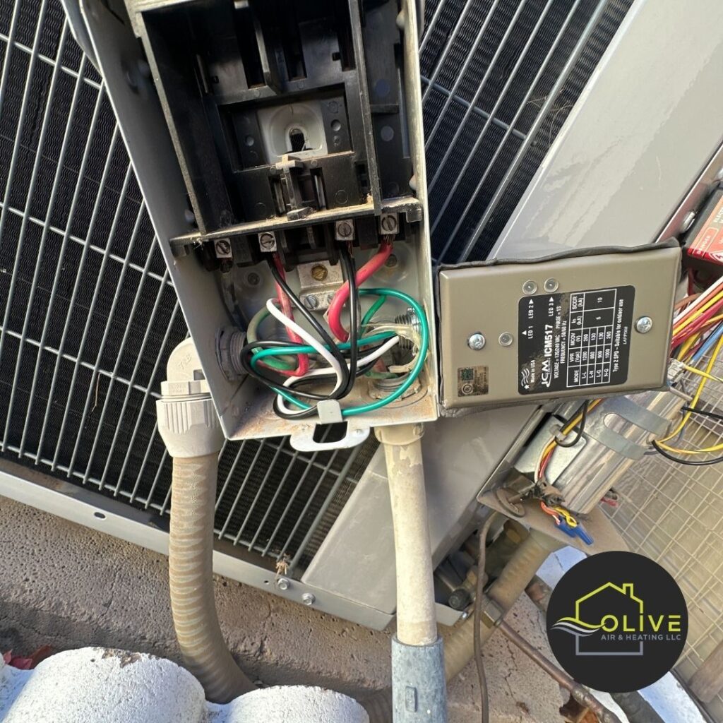 A close-up of an outdated electrical box and control panel on an air conditioning unit, highlighting the need for an AC upgrade to improve efficiency and reliability