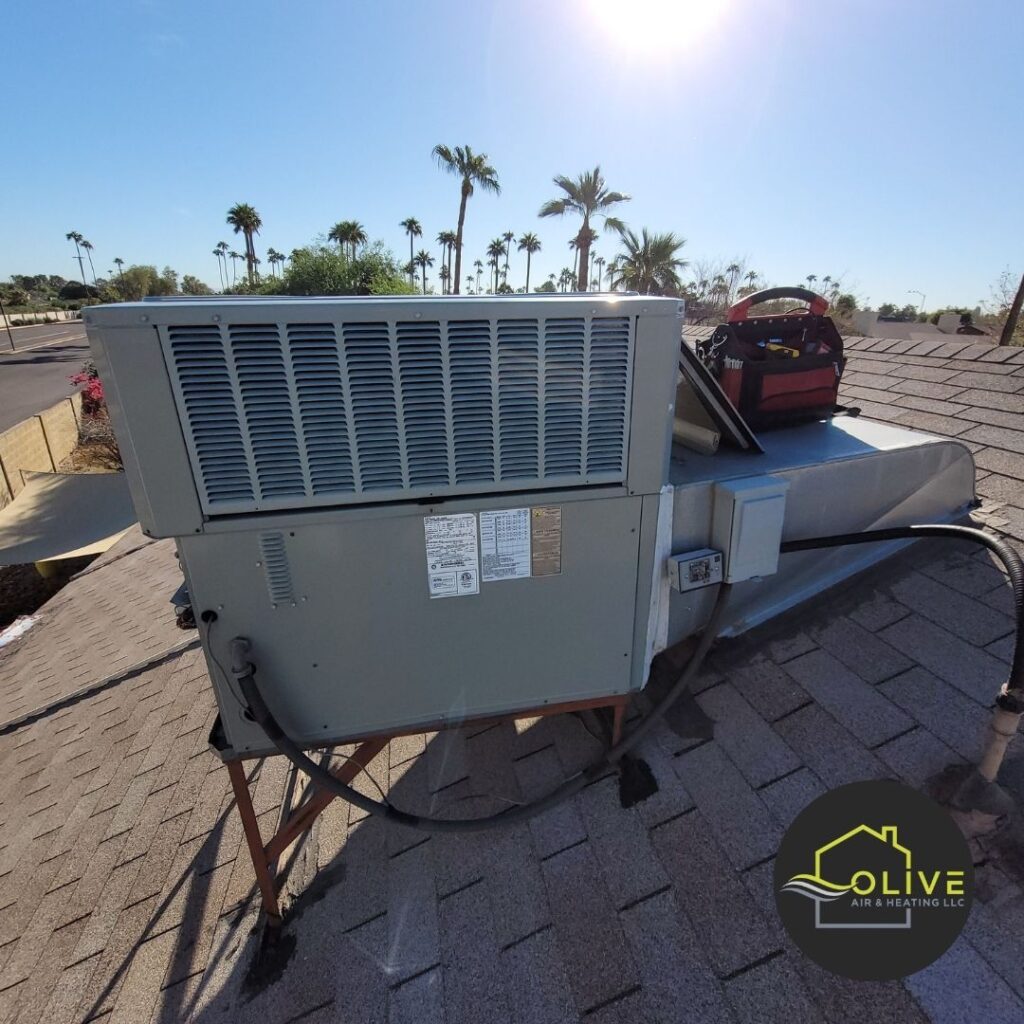 An image of an outdoor AC unit on a rooftop, showing the condenser coil and other components. Regular AC maintenance can help keep the outdoor unit clean and running efficiently.