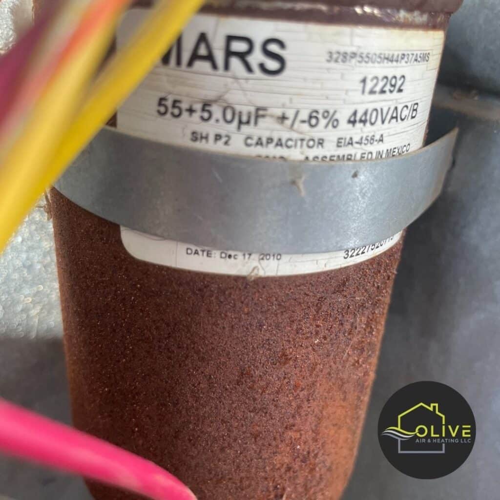 A close-up image of a corroded air conditioner capacitor, highlighting the importance of regular AC maintenance and timely repairs to prevent breakdowns. AC Repair Gilbert