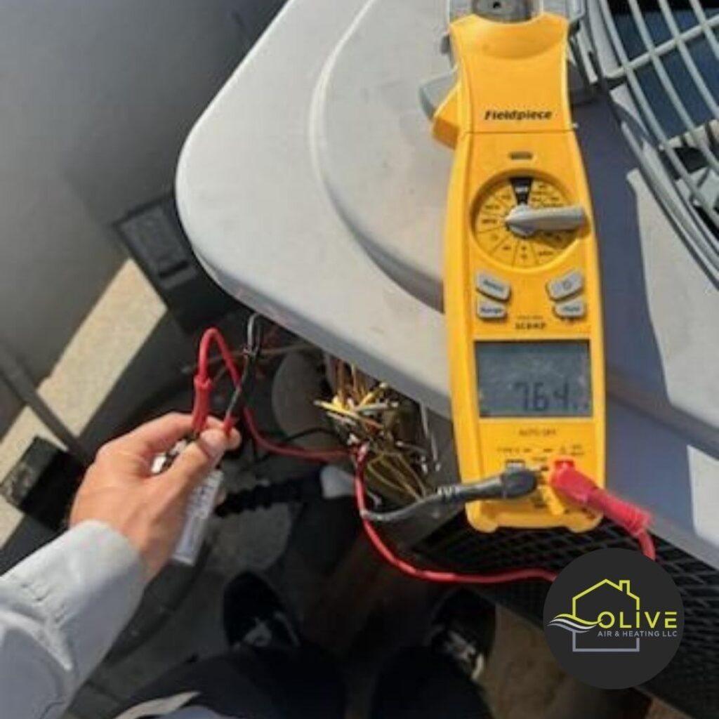 A technician using a multimeter to measure voltage and current in an outdoor AC unit. Regular AC and heating tune ups include electrical inspections to identify and address potential issues, such as faulty wiring or malfunctioning components.