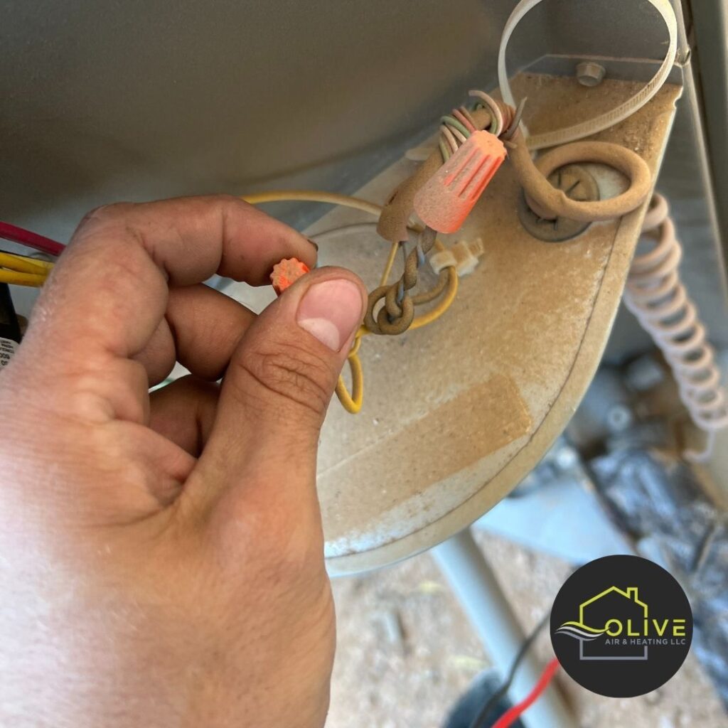 A close-up of exposed electrical wiring in an air conditioning unit, highlighting the risks of DIY HVAC maintenance Ac and Heating tune Up AC Repair Queen Creek