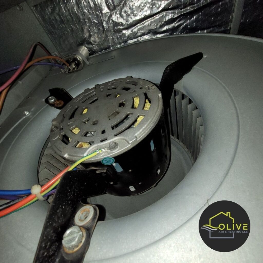 A close-up image of a worn-out AC blower motor, showing visible signs of damage and wear. A faulty blower motor can cause the AC unit to shut off unexpectedly. AC Repair