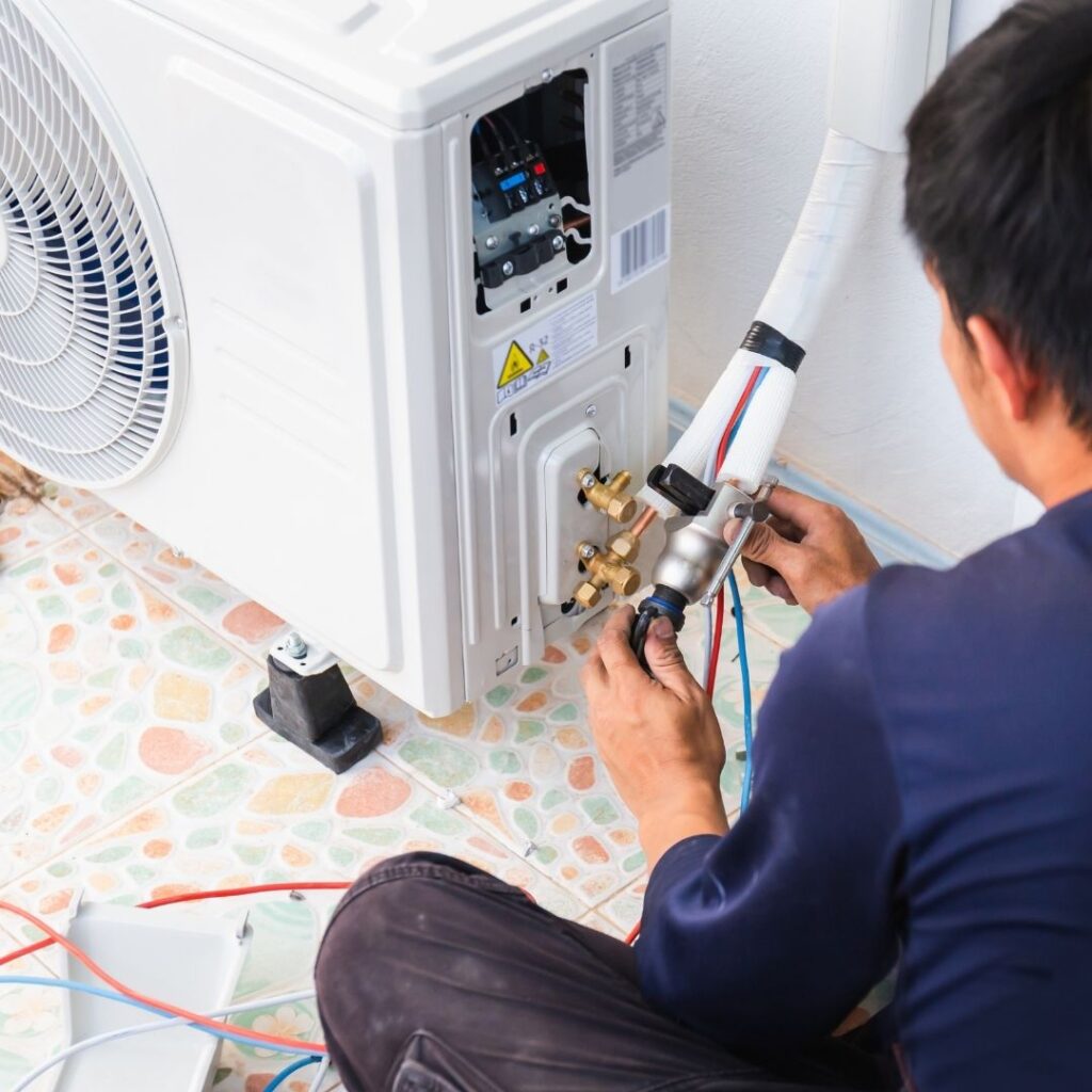 A skilled HVAC technician working efficiently to repair an air conditioning unit in a San Tan Valley, Arizona home. AC Repair San Tan Valley