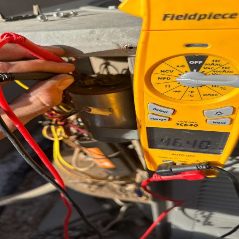 Technician Diagnosing AC Unit with a Multimeter AC Repair