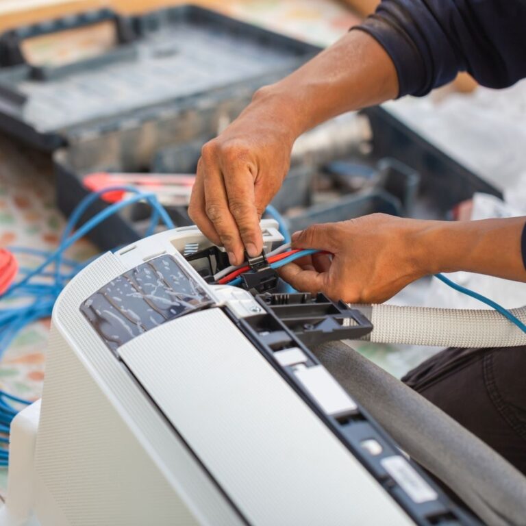 A technician working on the electrical wiring of an air conditioning unit, highlighting the expertise needed for reliable heating repair services in Sun City West.