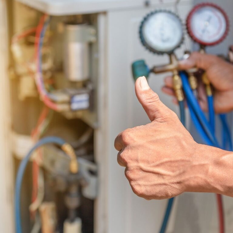 A technician using a digital multimeter to diagnose an electrical issue within a furnace as part of professional Furnace Services in Queen Creek.