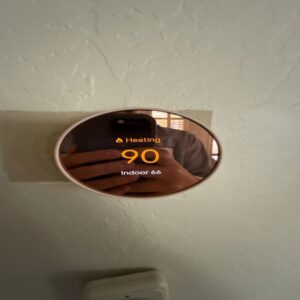 A Nest thermostat displaying a high heating temperature, highlighting the importance of professional heating repair to ensure efficient and safe home heating.