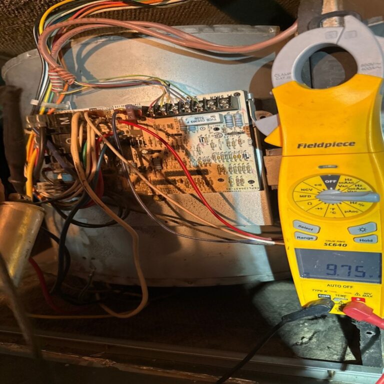 Close-up image of an HVAC technician using a multimeter to diagnose a heating system issue. Heating Repair