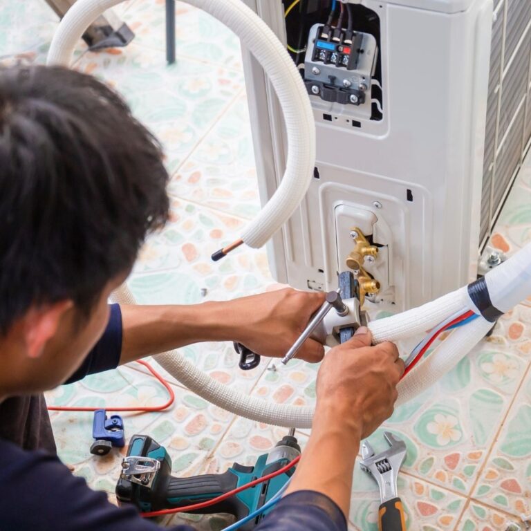 A technician inspecting a heating system component, emphasizing the importance of professional heating repair services in Queen Creek to maintain a warm and comfortable home.