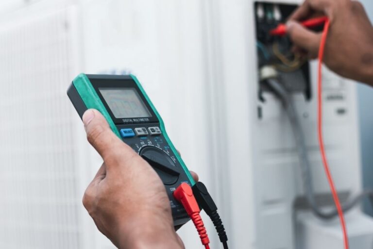 A technician using a multimeter to diagnose a potential issue with a furnace, highlighting the importance of professional Furnace Services in Tolleson for maintaining optimal heating system performance.